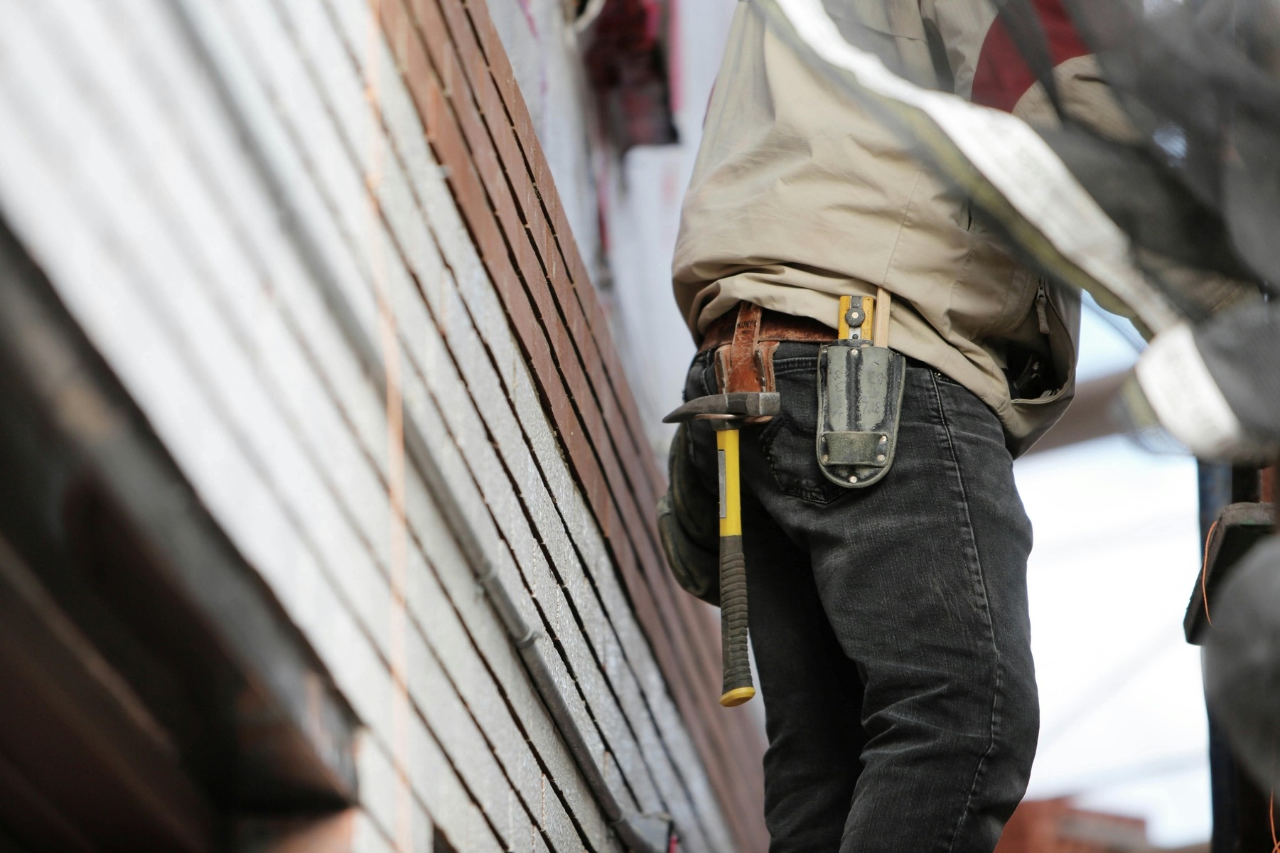 Hammer hanging on man's belt 