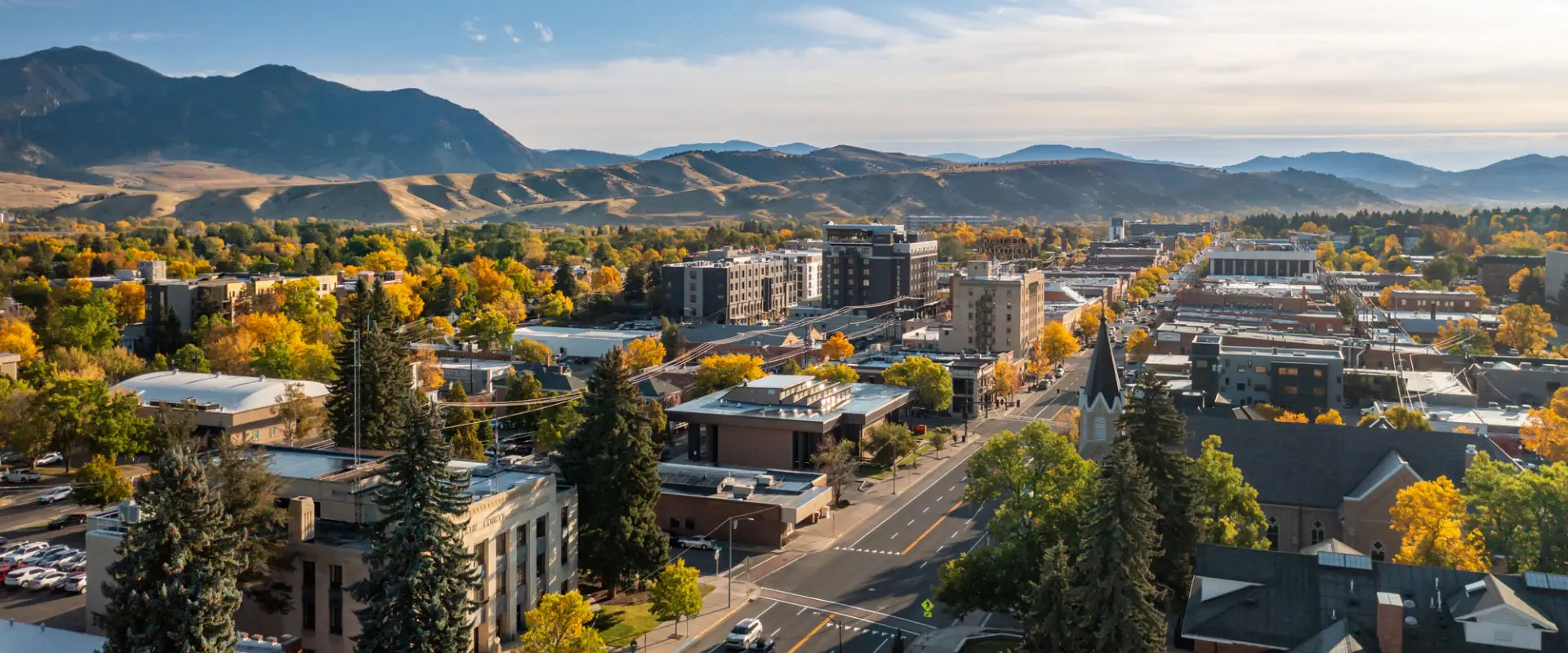 Downtown Montana cityscape with mountains in the background, showcasing the community Demo Pros serves with dust-free demolition services.