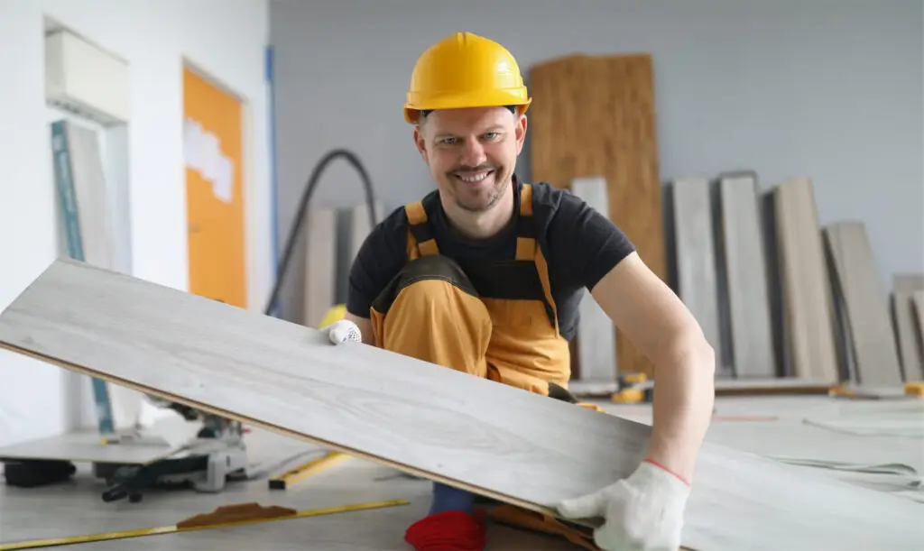 Demo Pros technician carrying wooden plank during dust-free residential demolition project in Montana.