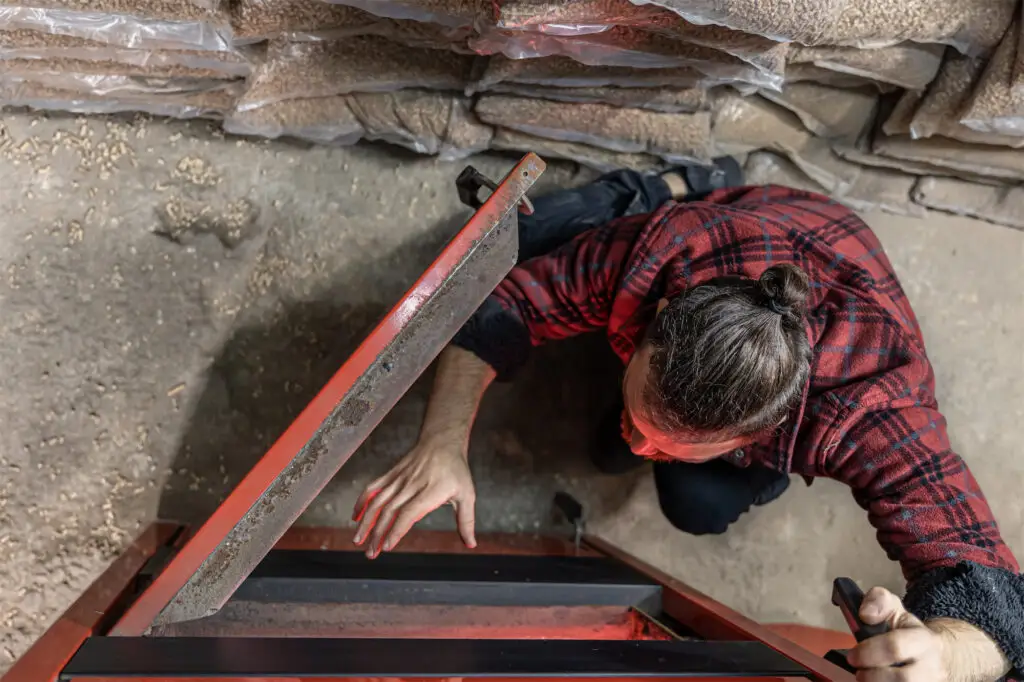 "Demo Pros technician inspecting solid fuel boiler during dust-free demolition preparation in Montana.