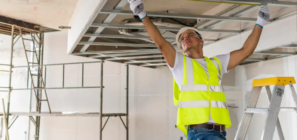 Finisher installing ceiling framework in a clean, prepped space made possible by Demo Pros’ dust-free commercial demolition in Montana.