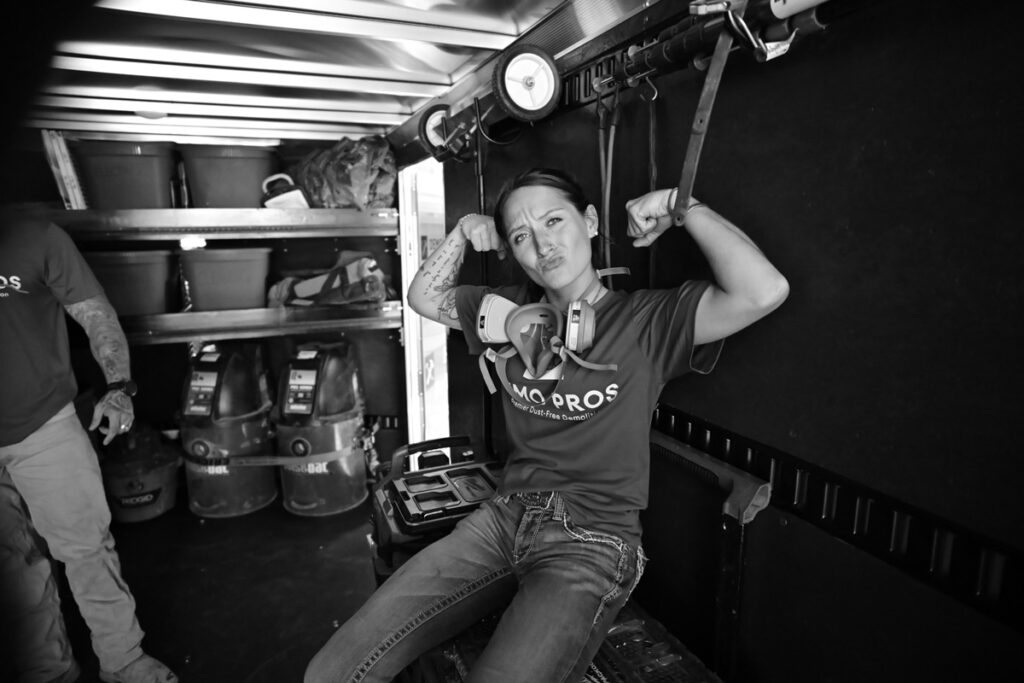 Demo Pros team member flexing