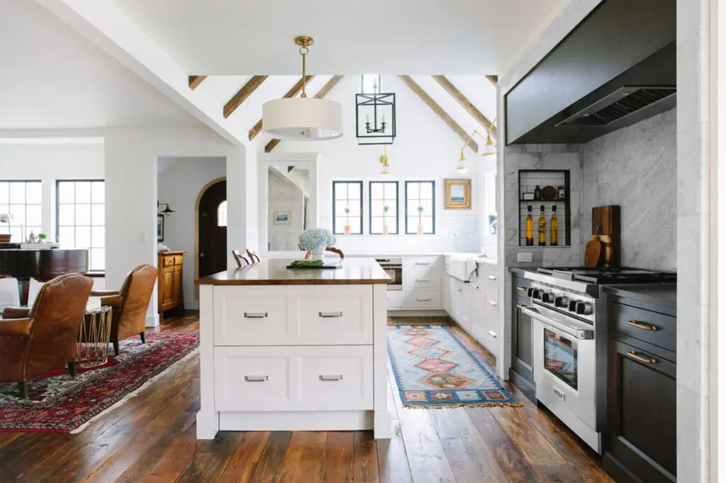 Stunning farmhouse kitchen featuring a freestanding tub, glass-enclosed shower, and wooden vanity in a modern Montana home.